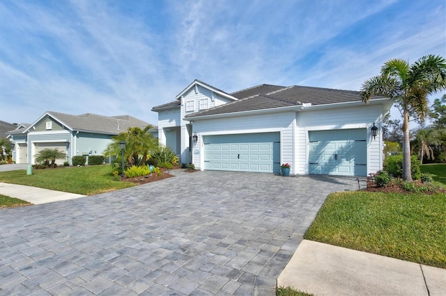 view of front of home with a garage and a front lawn