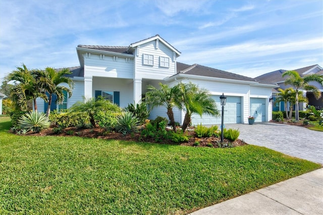 view of front of property featuring a garage and a front lawn