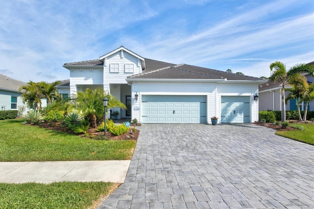 view of front of property with a garage and a front yard