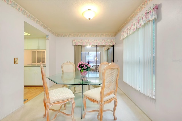 dining space with light carpet