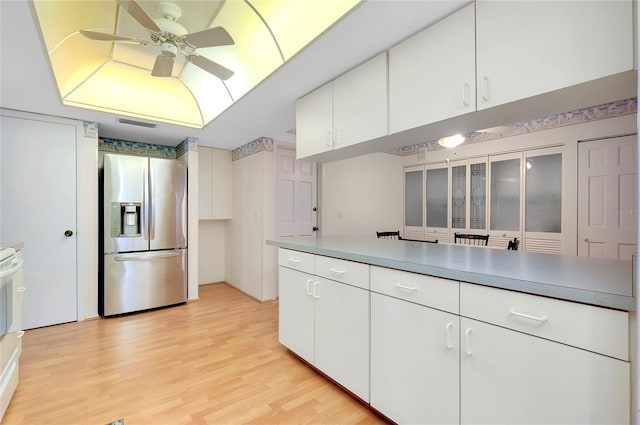 kitchen with white cabinetry, stainless steel fridge, and ceiling fan