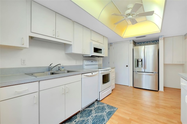 kitchen with white appliances, white cabinetry, sink, light wood-type flooring, and ceiling fan