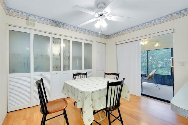 dining area featuring light wood-type flooring and ceiling fan