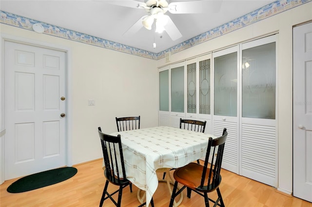 dining room with ceiling fan and light wood-type flooring