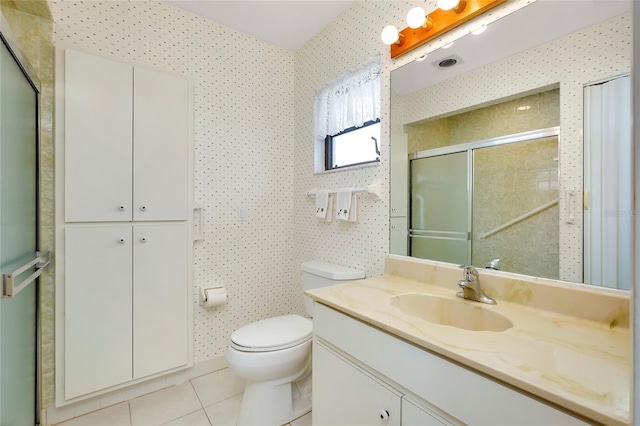 bathroom featuring a shower with shower door, tile patterned floors, vanity, and toilet