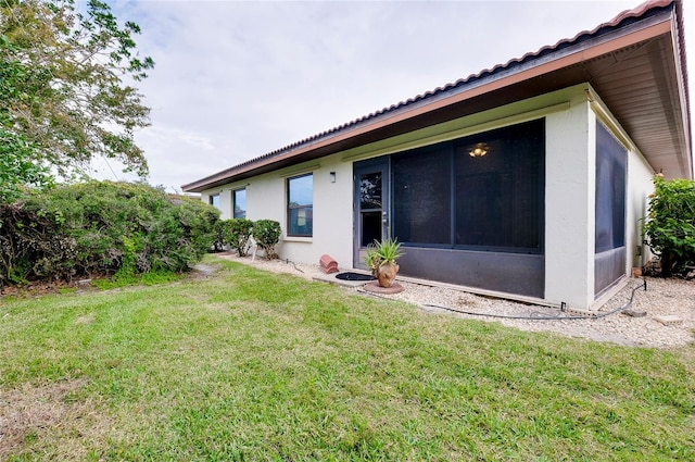 rear view of house featuring a lawn