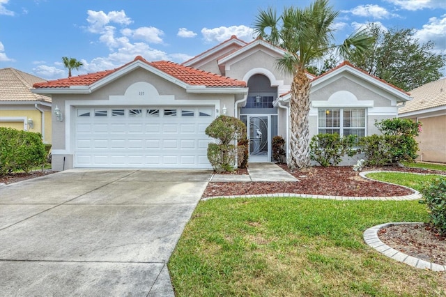 mediterranean / spanish-style home with a garage and a front lawn