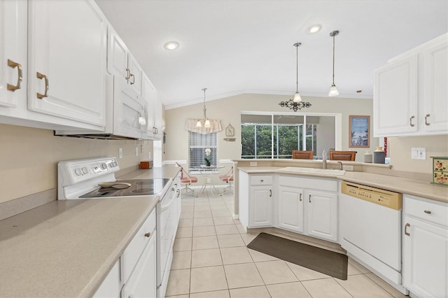 kitchen with pendant lighting, white appliances, white cabinets, lofted ceiling, and sink