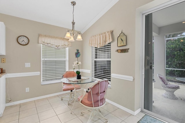 tiled dining space featuring crown molding, an inviting chandelier, and vaulted ceiling