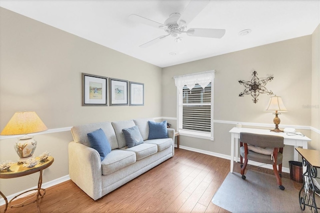 living room featuring hardwood / wood-style flooring and ceiling fan