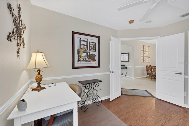 office area with ceiling fan and hardwood / wood-style floors