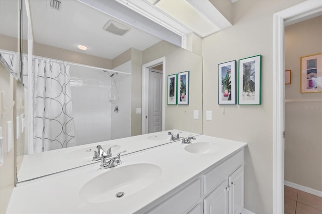 bathroom with tile patterned floors, walk in shower, and vanity