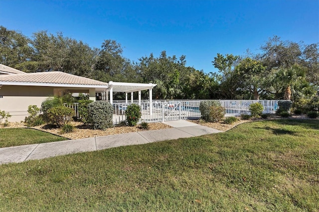 view of home's community with a swimming pool, a pergola, and a lawn