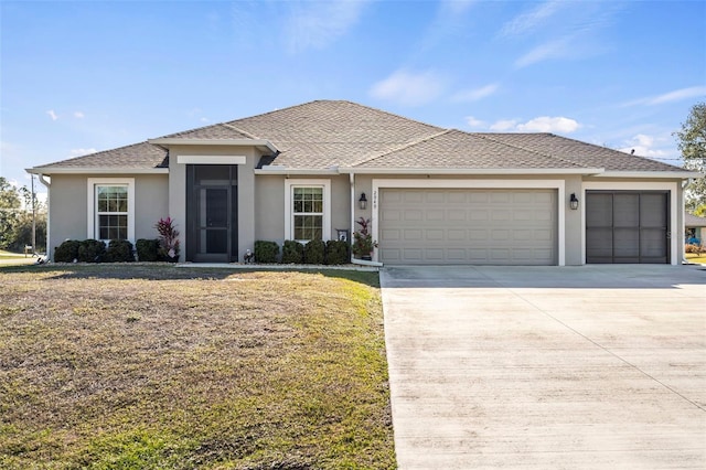 view of front of home with a garage and a front lawn