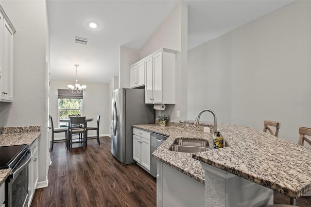 kitchen featuring white cabinetry, pendant lighting, a kitchen breakfast bar, and kitchen peninsula