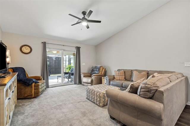 living room featuring vaulted ceiling, carpet floors, and ceiling fan