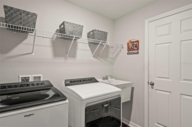 clothes washing area with washing machine and dryer