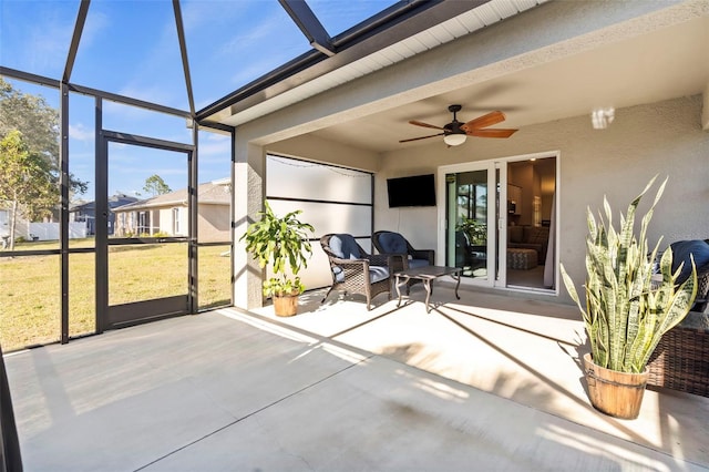 unfurnished sunroom featuring ceiling fan