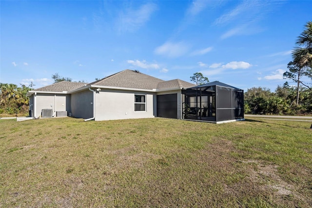 rear view of property featuring a lanai, a lawn, and central air condition unit