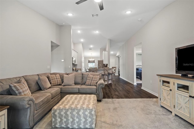 2949 Jaylene Rd, North Port, FL 34288 - living room featuring dark wood-style flooring, ceiling fan, dark colored carpet, baseboards, and visible vents