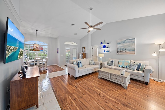 living room with ceiling fan, light hardwood / wood-style flooring, and lofted ceiling