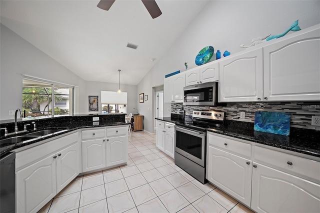 kitchen featuring appliances with stainless steel finishes, decorative light fixtures, sink, white cabinetry, and lofted ceiling