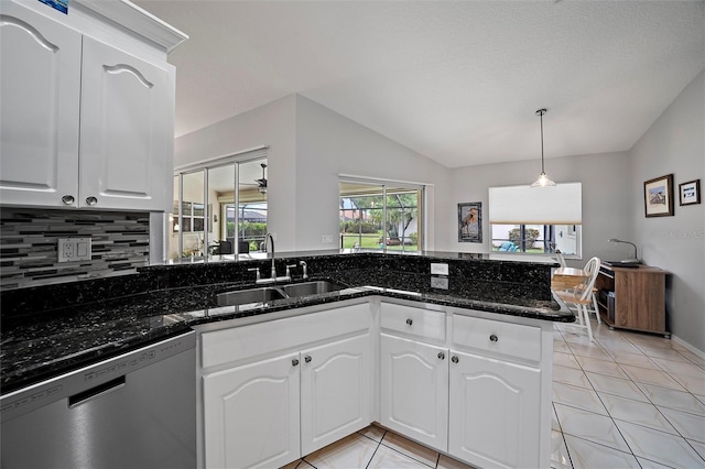 kitchen featuring stainless steel dishwasher, sink, decorative light fixtures, white cabinetry, and lofted ceiling