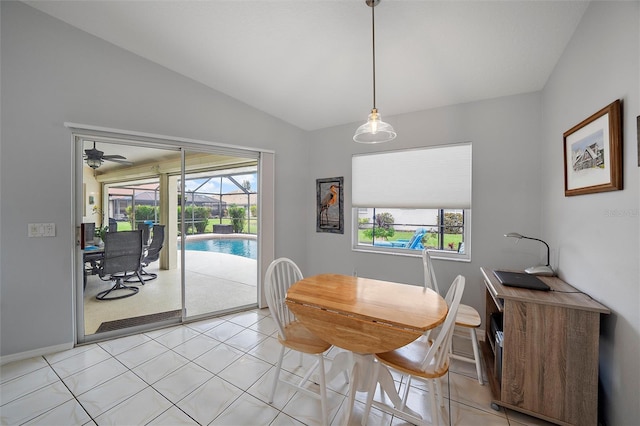 tiled dining area with vaulted ceiling