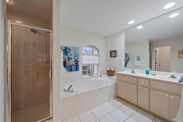 bathroom featuring vanity, independent shower and bath, tile patterned floors, and a textured ceiling