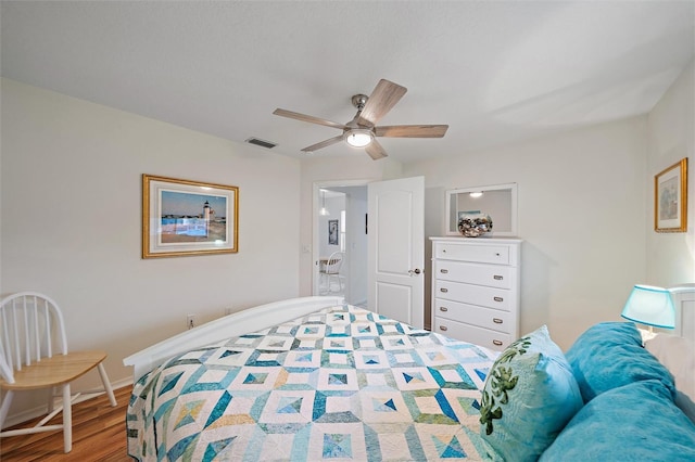 bedroom with ceiling fan and hardwood / wood-style floors