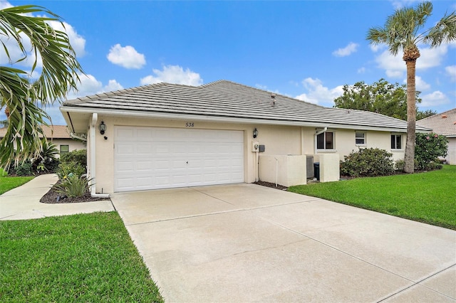 ranch-style house featuring a garage and a front lawn