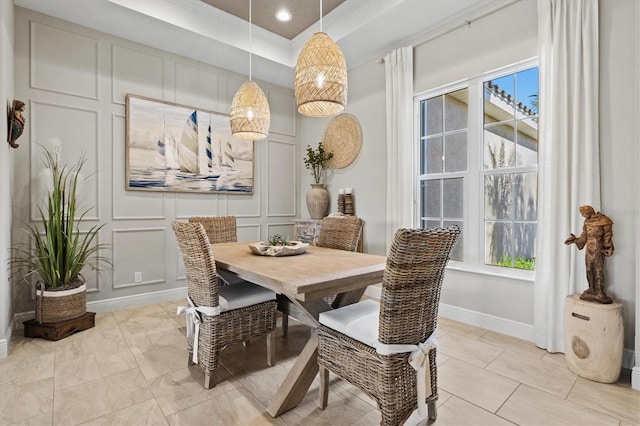 tiled dining room with a wealth of natural light and a raised ceiling