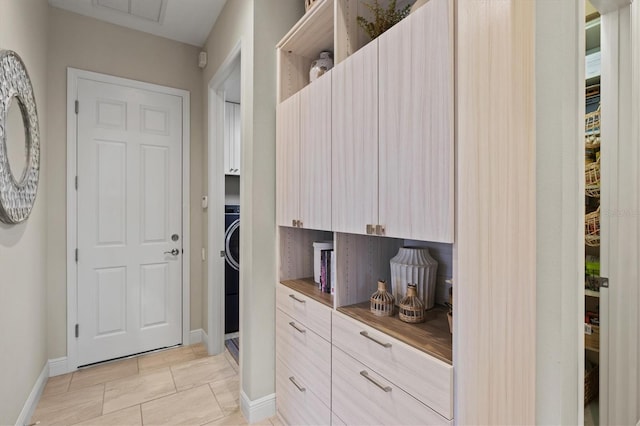 kitchen with light tile patterned flooring and light brown cabinets