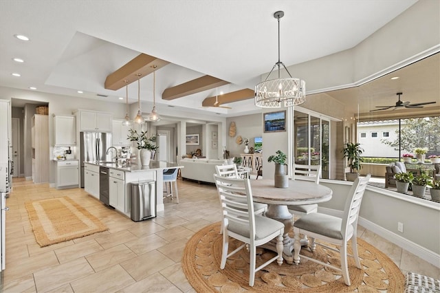 tiled dining space featuring a tray ceiling and ceiling fan with notable chandelier