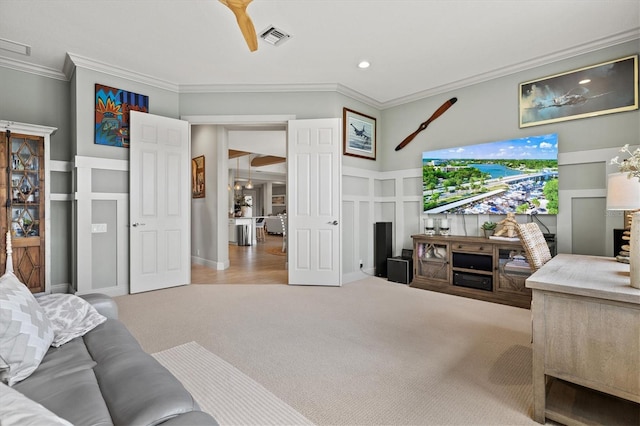 living room featuring ornamental molding and carpet flooring