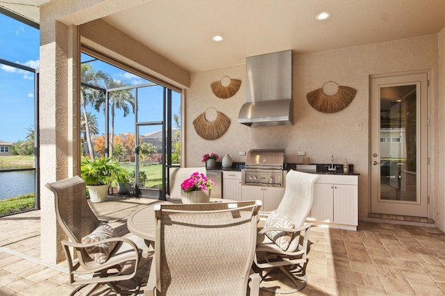 sunroom / solarium with sink and a water view