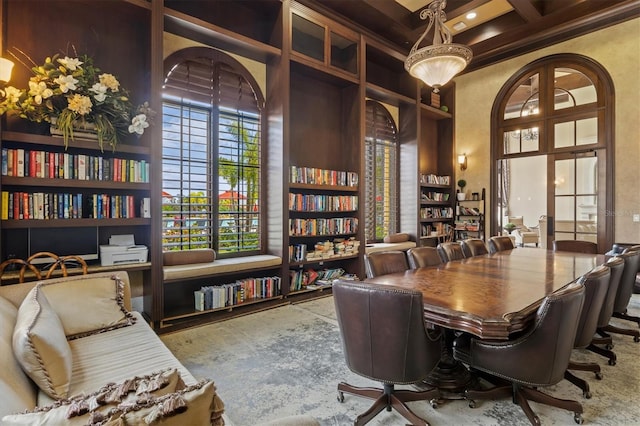 home office with a healthy amount of sunlight, coffered ceiling, crown molding, and beam ceiling