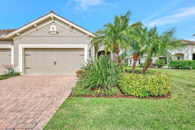 view of front of house with a garage and a front lawn