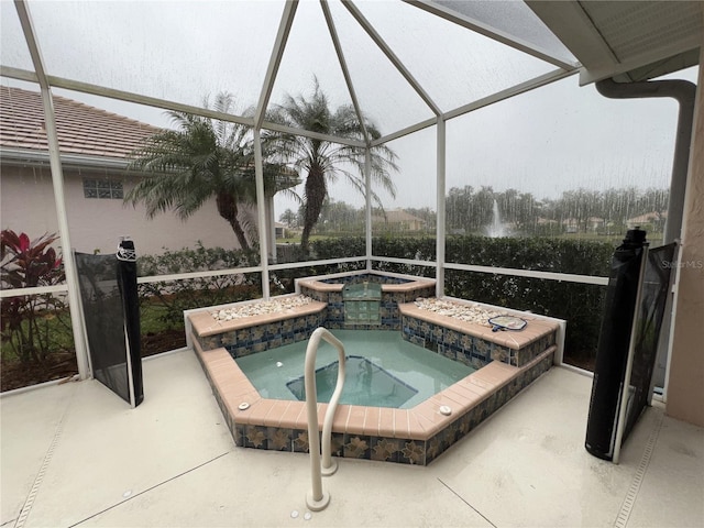 view of pool featuring an in ground hot tub, a lanai, and a patio area