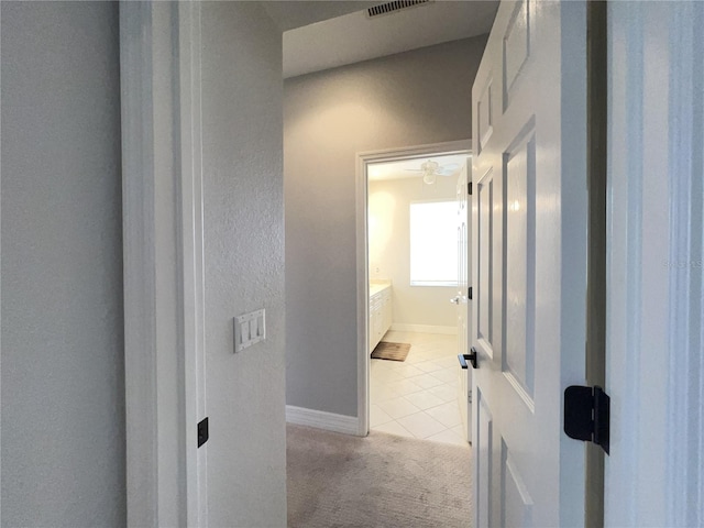 hallway with light colored carpet