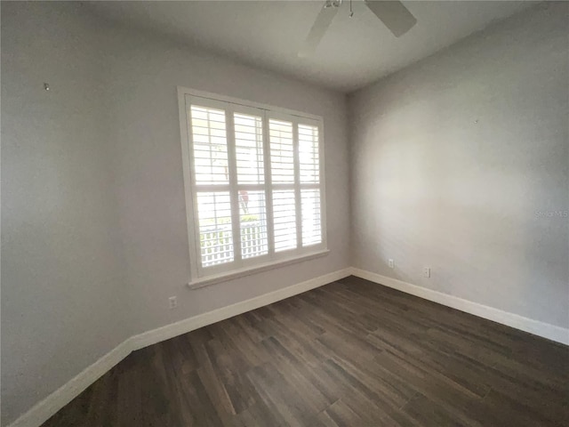 unfurnished room featuring dark hardwood / wood-style floors and ceiling fan