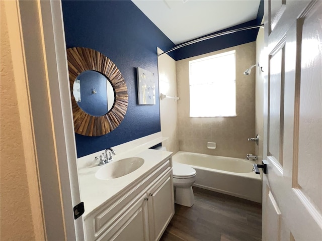 full bathroom featuring vanity, toilet, hardwood / wood-style floors, and tiled shower / bath combo