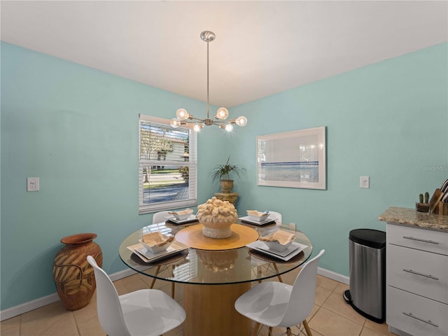 1423 Avenida Del Circo Unit 1C, Venice, FL 34285 - dining room featuring light tile patterned flooring, a chandelier, and baseboards