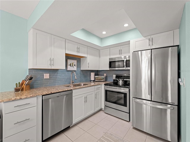 1423 Avenida Del Circo Unit 1C, Venice, FL 34285 - kitchen with stainless steel appliances, a sink, white cabinetry, light tile patterned floors, and recessed lighting