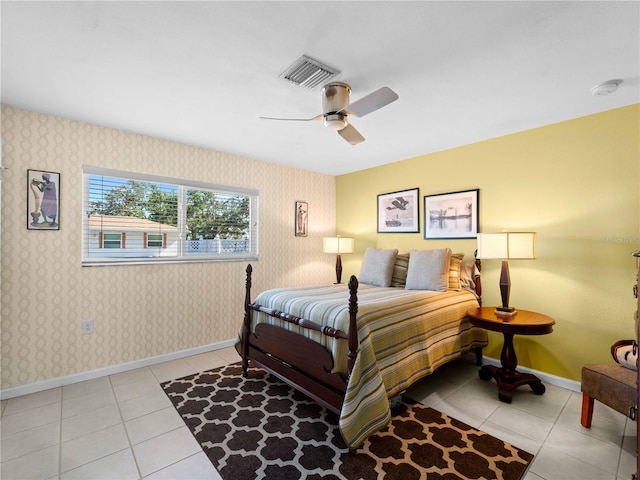 1423 Avenida Del Circo Unit 1C, Venice, FL 34285 - bedroom with baseboards, tile patterned floors, a ceiling fan, and wallpapered walls
