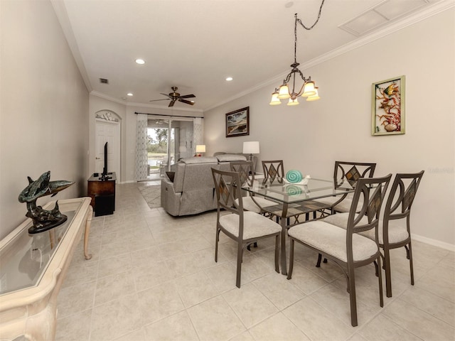 dining area with light tile patterned floors and crown molding