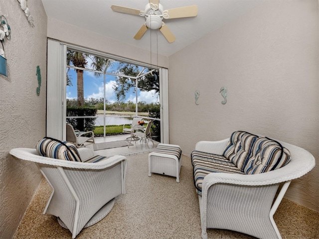 interior space featuring a water view and ceiling fan