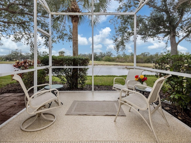 sunroom / solarium with a water view