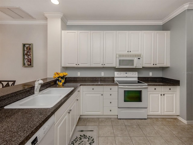 kitchen with sink, white appliances, white cabinets, and light tile patterned flooring