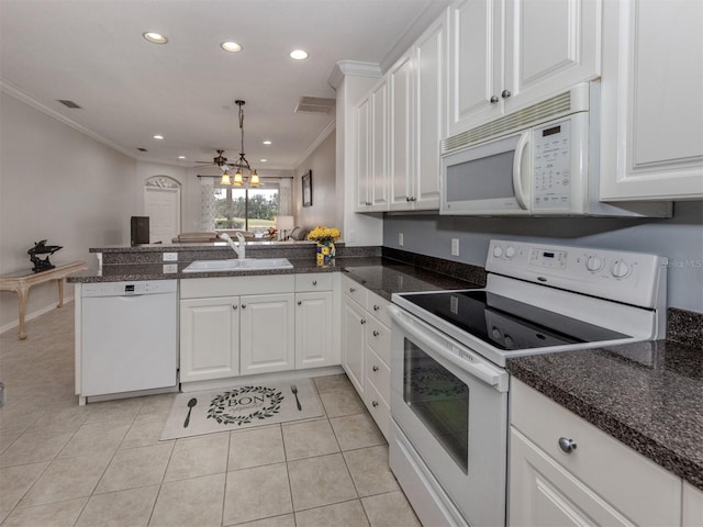 kitchen featuring sink, white cabinets, white appliances, and kitchen peninsula